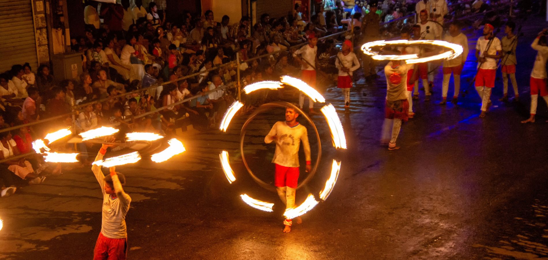 Fire dancers parading during the Esala Perahera in Kandy, an iconic traditional procession celebrating Sri Lankan culture.